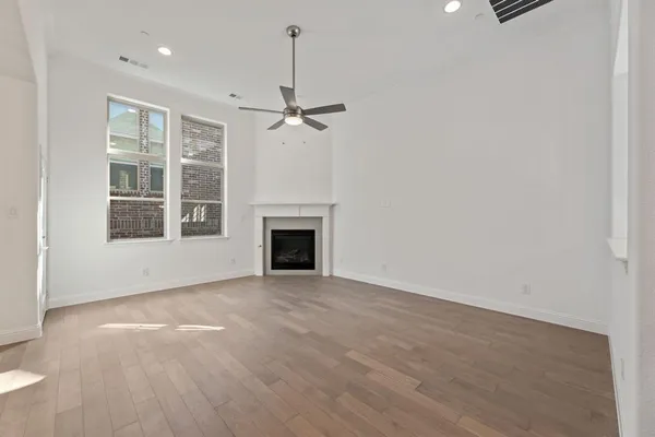 wooden floor in an empty room with a fireplace