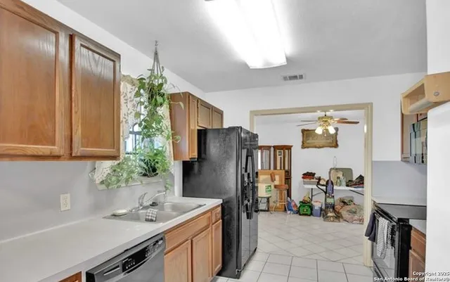 a kitchen with a refrigerator and a sink