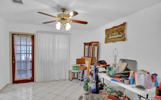 a workspace with furniture and fan