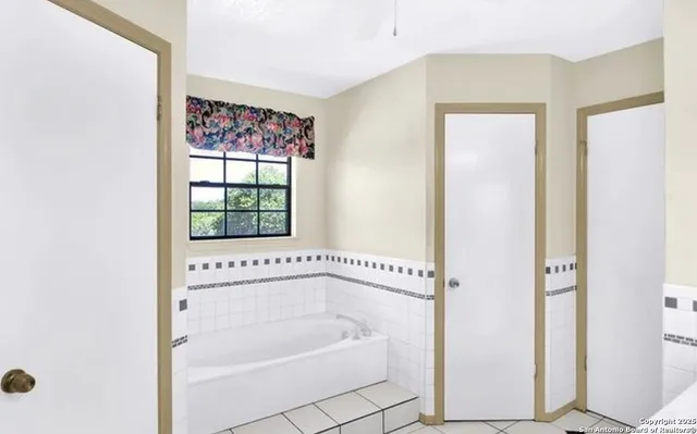 a bathroom with a bathtub and a shower