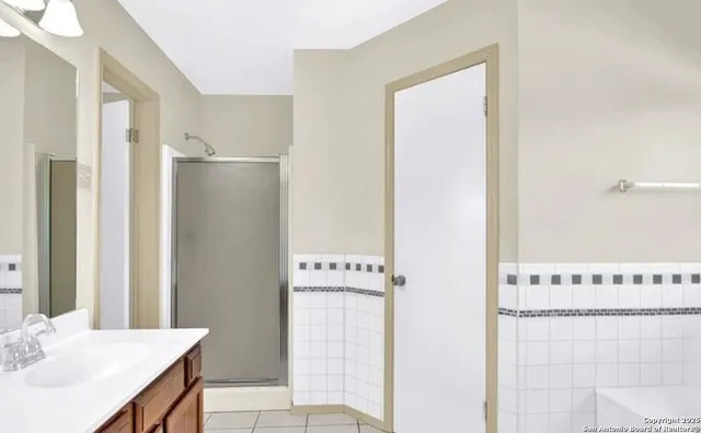 a bathroom with a sink a mirror and a shower