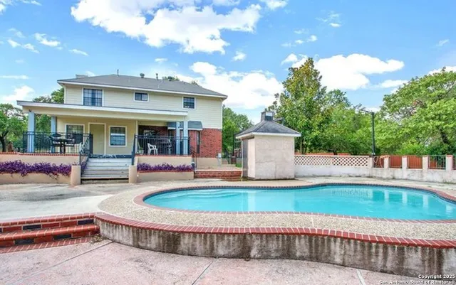 a front view of a house with a yard glass top table and chairs
