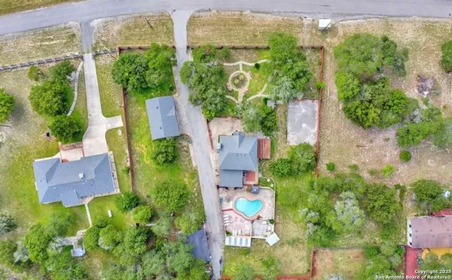 an aerial view of a house with yard swimming pool and outdoor seating