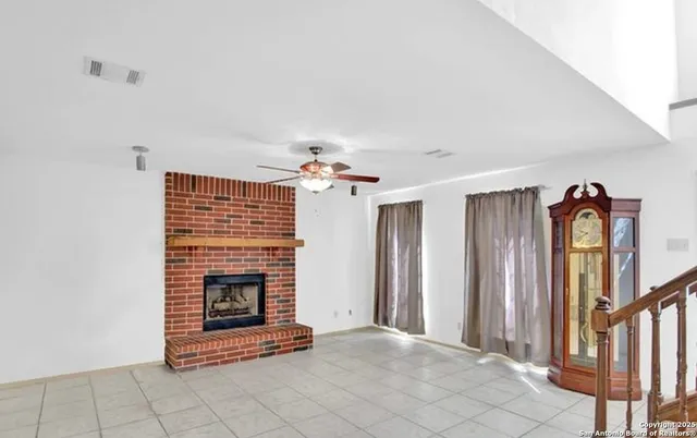 a view of an empty room with a fireplace and a window
