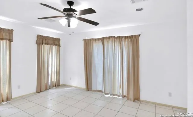 a view of a livingroom with a chandelier fan