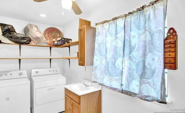 a bathroom with a sink a vanity and a shower curtain