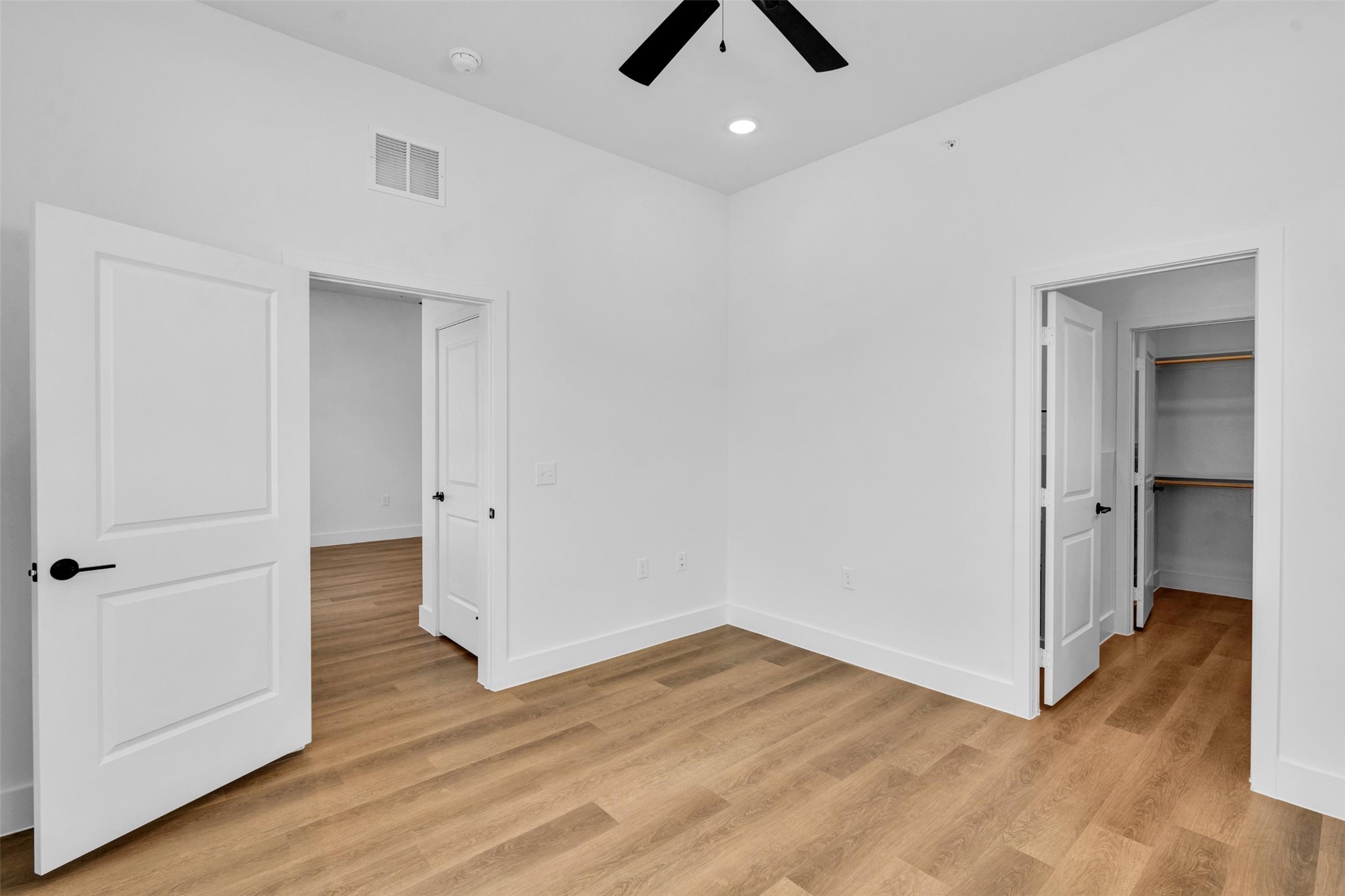 1418 B Forward Drive Little Elm, TX 75068 - Photo 18 of 38 an empty room with wooden floor and ceiling fan