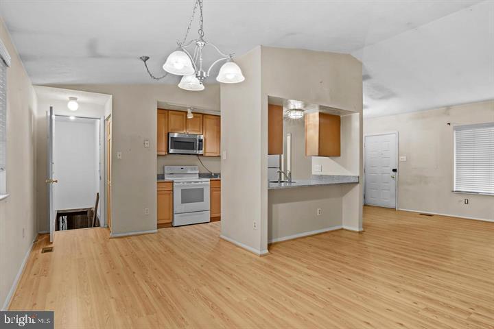 8406 Rainbow Bridge Lane Springfield, VA 22153 - Photo 2 of 8 a view of a kitchen with wooden floor and a large window
