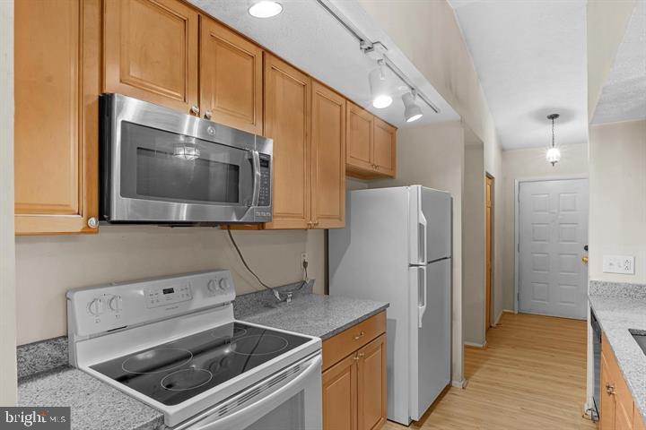 8406 Rainbow Bridge Lane Springfield, VA 22153 - Photo 3 of 8 a kitchen with a refrigerator stove and microwave
