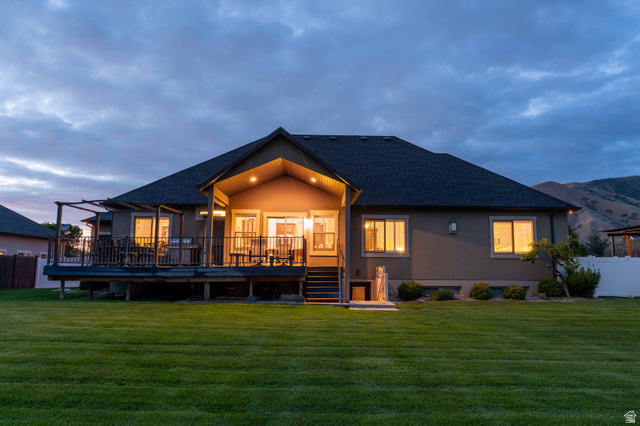 646 East 1400th Street North Mapleton, UT 84664 - Photo 8 of 78 Expansive backyard featuring a manicured lawn, a full-width raised deck, and a covered patio area with recessed lighting