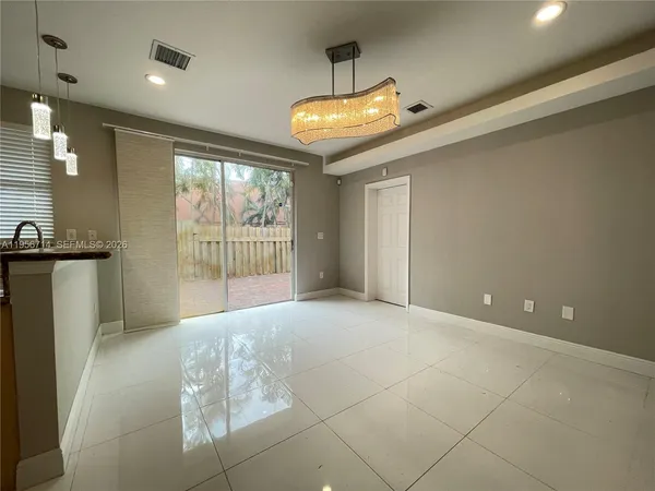 a view of a hallway with a chandelier