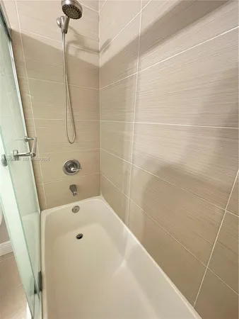a bathroom with a sink toilet vanity and shower