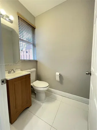 a bathroom with a toilet sink and window