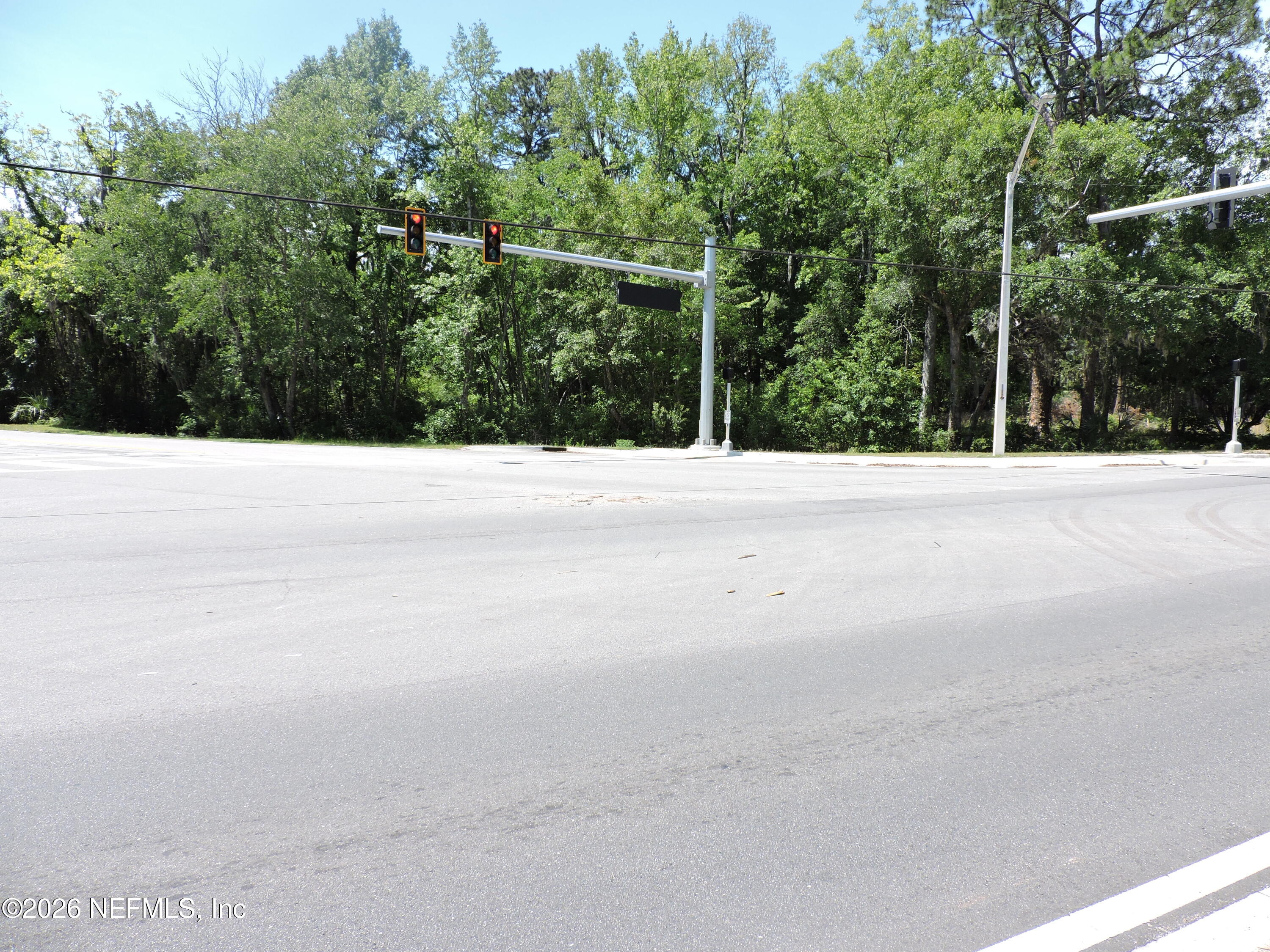 3713 Cedar Point Road Jacksonville, FL 32226 - Photo 8 of 24 a view of a field with trees in the background
