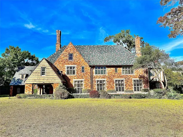 a front view of a house with a garden and deck