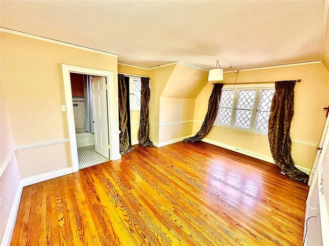 a view of an empty room with a fireplace and a window