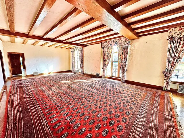 a bedroom with a bed and a rug