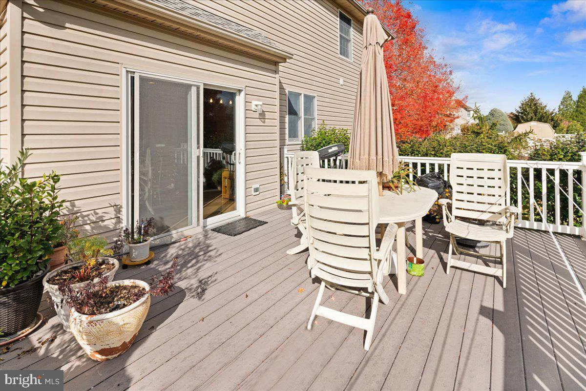 1 Gardengate Court Columbus, NJ 08022 - Photo 36 of 41 a view of a roof deck with wooden floor and fence