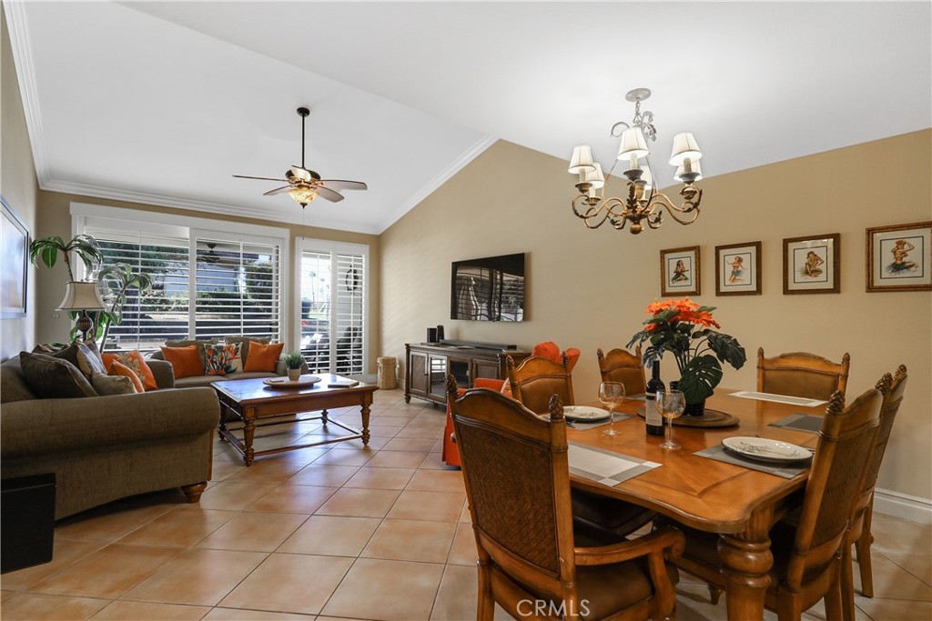 a living room with furniture chandelier and a flat screen tv