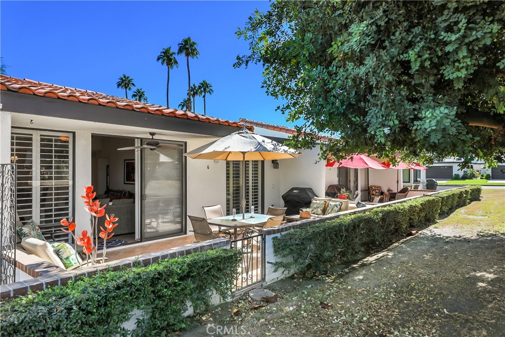 6 Tortosa Drive Rancho Mirage, CA 92270 - Photo 23 of 24 a front view of a house with porch and garden