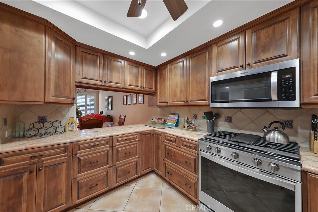 6 Tortosa Drive Rancho Mirage, CA 92270 - Photo 8 of 24 a kitchen with stainless steel appliances granite countertop a stove and a sink