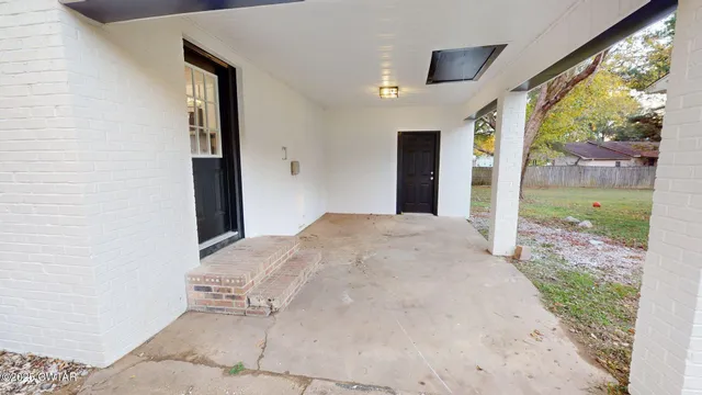 a view of a big room with a floor to ceiling window and yard