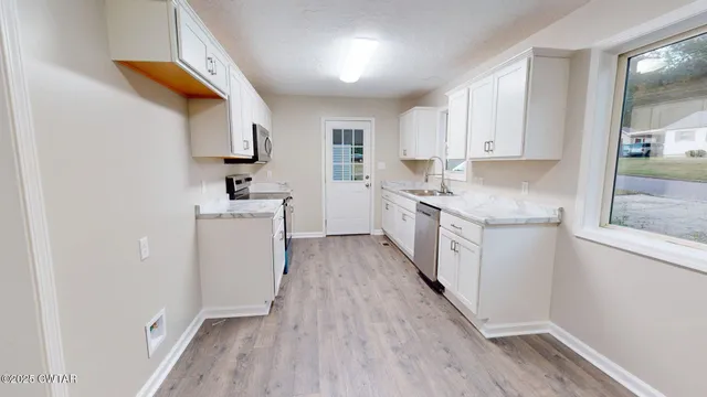 a kitchen with a sink a cabinets and window