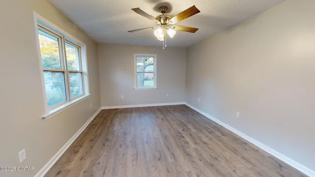 wooden floor in an empty room with a window