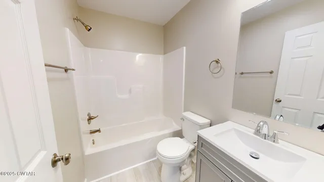 a bathroom with a sink toilet tub and shower