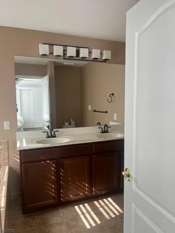 a bathroom with a sink double vanity and a mirror