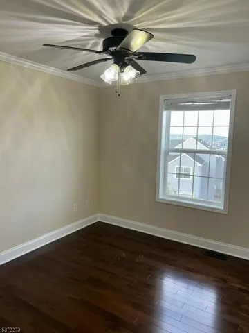 a view of a room with wooden floor closet and windows