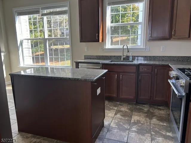 a kitchen with a sink a counter top space and cabinets