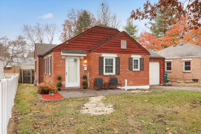 a front view of a house with a yard and outdoor seating
