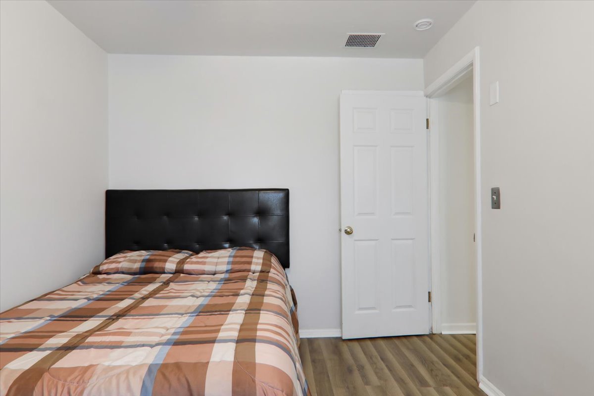 1812 Shady Crest Street Decatur, IL 62521 - Photo 12 of 16 a bedroom with a bed and wooden floor