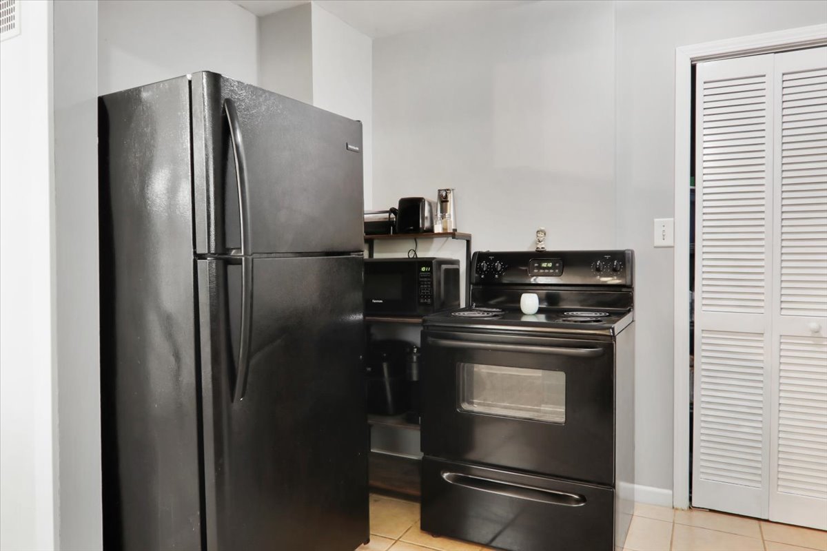 1812 Shady Crest Street Decatur, IL 62521 - Photo 8 of 16 a metallic refrigerator freezer sitting in a kitchen