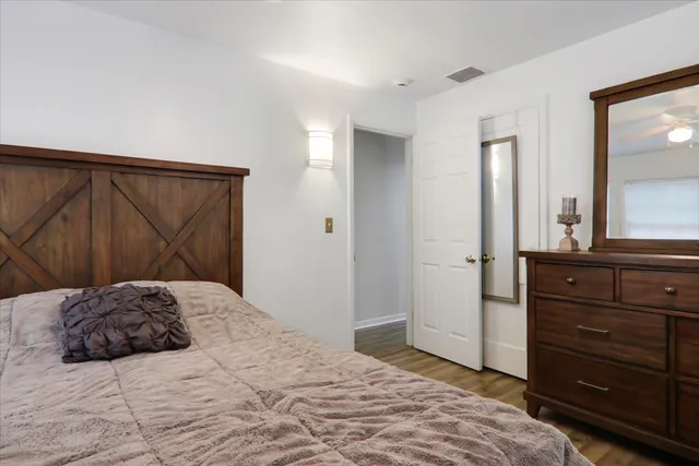 a bedroom with a large bed and a mirror