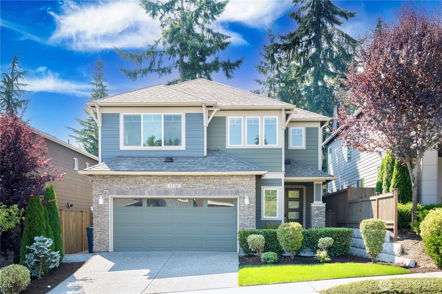 a front view of a house with a yard and garage