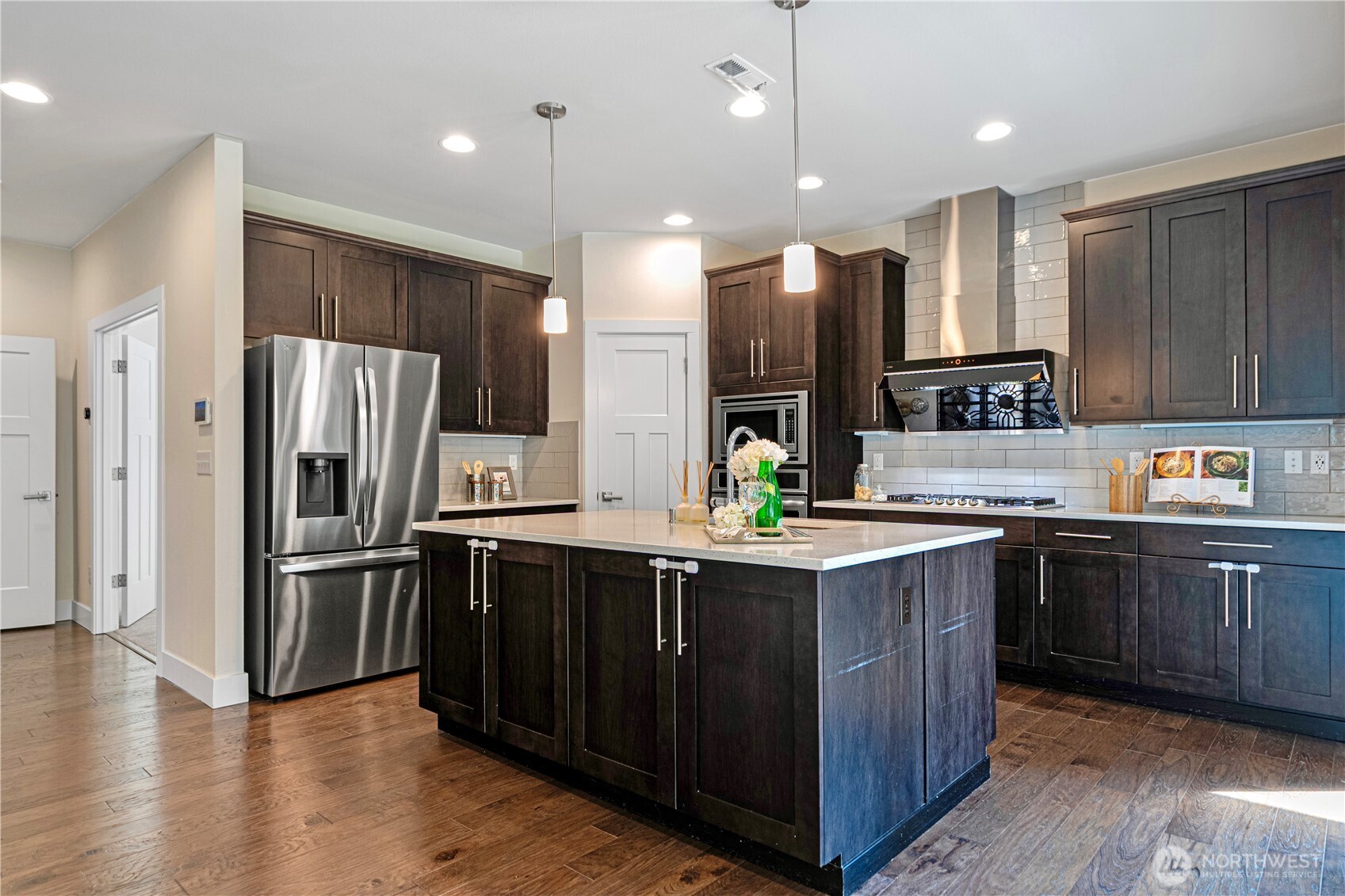 1130 199th Street Southeast Bothell, WA 98012 - Photo 12 of 33 a kitchen with kitchen island granite countertop stainless steel appliances a sink a counter top space cabinets and a center island