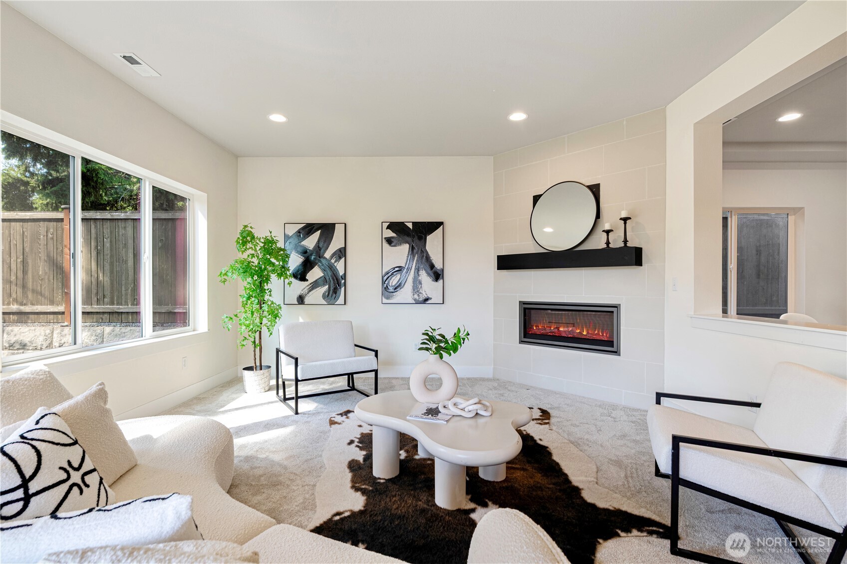 1130 199th Street Southeast Bothell, WA 98012 - Photo 14 of 33 a living room with furniture a fireplace a large window and potted plant