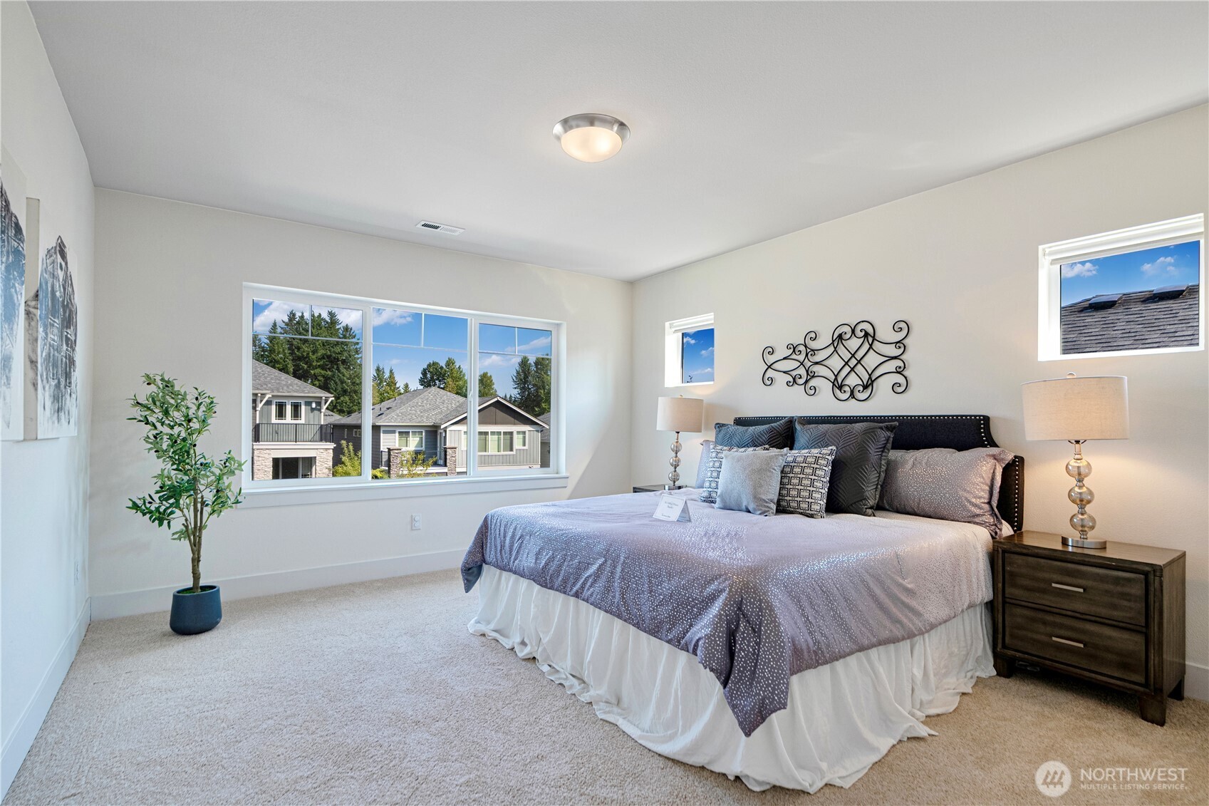1130 199th Street Southeast Bothell, WA 98012 - Photo 17 of 33 a bedroom with a large bed and a potted plant
