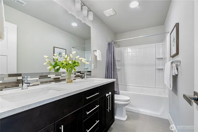 a bedroom with a bed and a potted plant