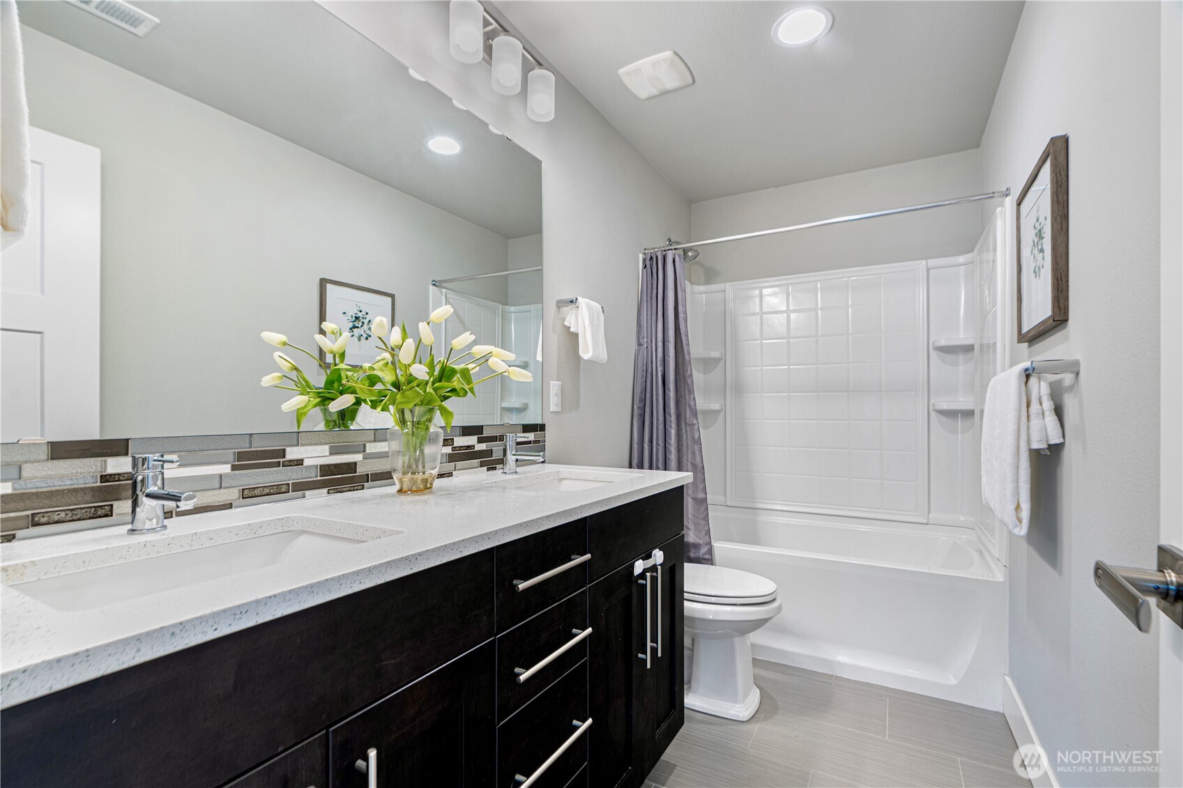 1130 199th Street Southeast Bothell, WA 98012 - Photo 20 of 33 a bathroom with a granite countertop sink a toilet a mirror a vanity and shower