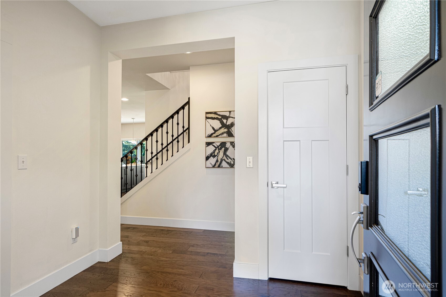1130 199th Street Southeast Bothell, WA 98012 - Photo 2 of 33 a view of a hallway with wooden floor and staircase