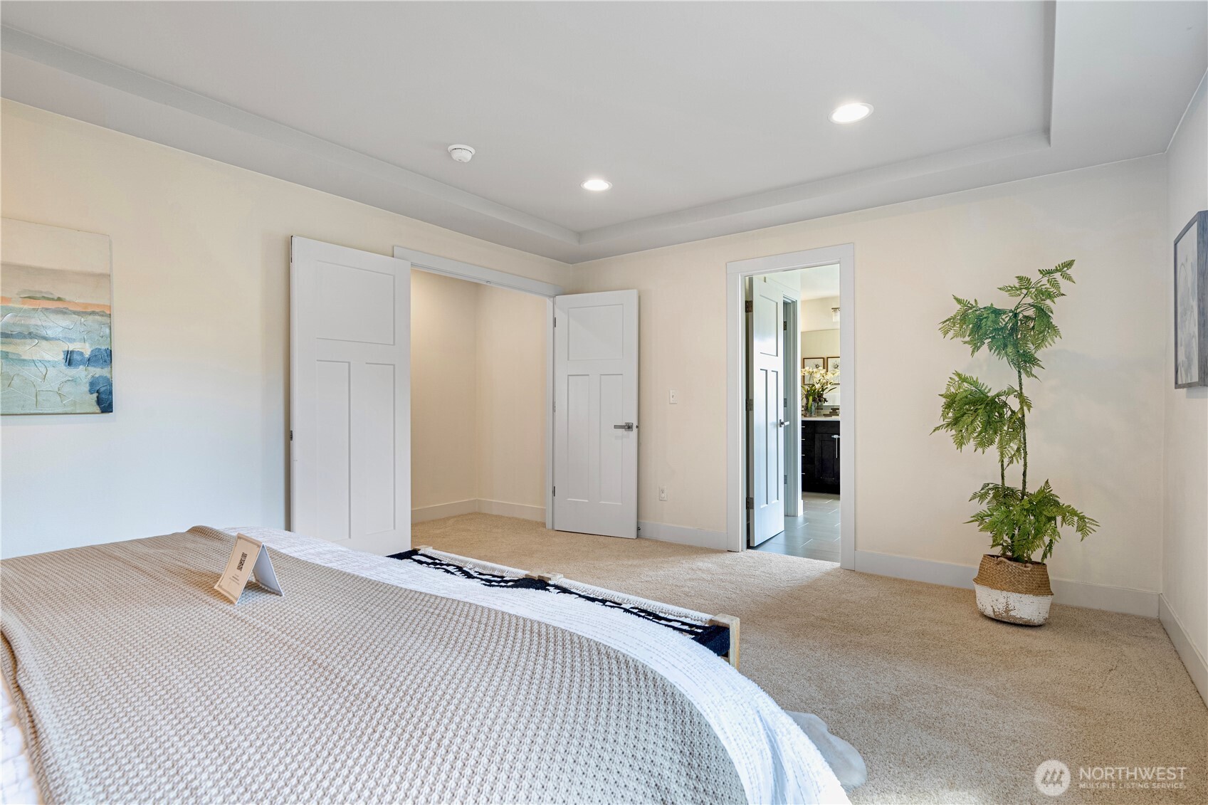 1130 199th Street Southeast Bothell, WA 98012 - Photo 22 of 33 a spacious bedroom with a bed and a potted plant
