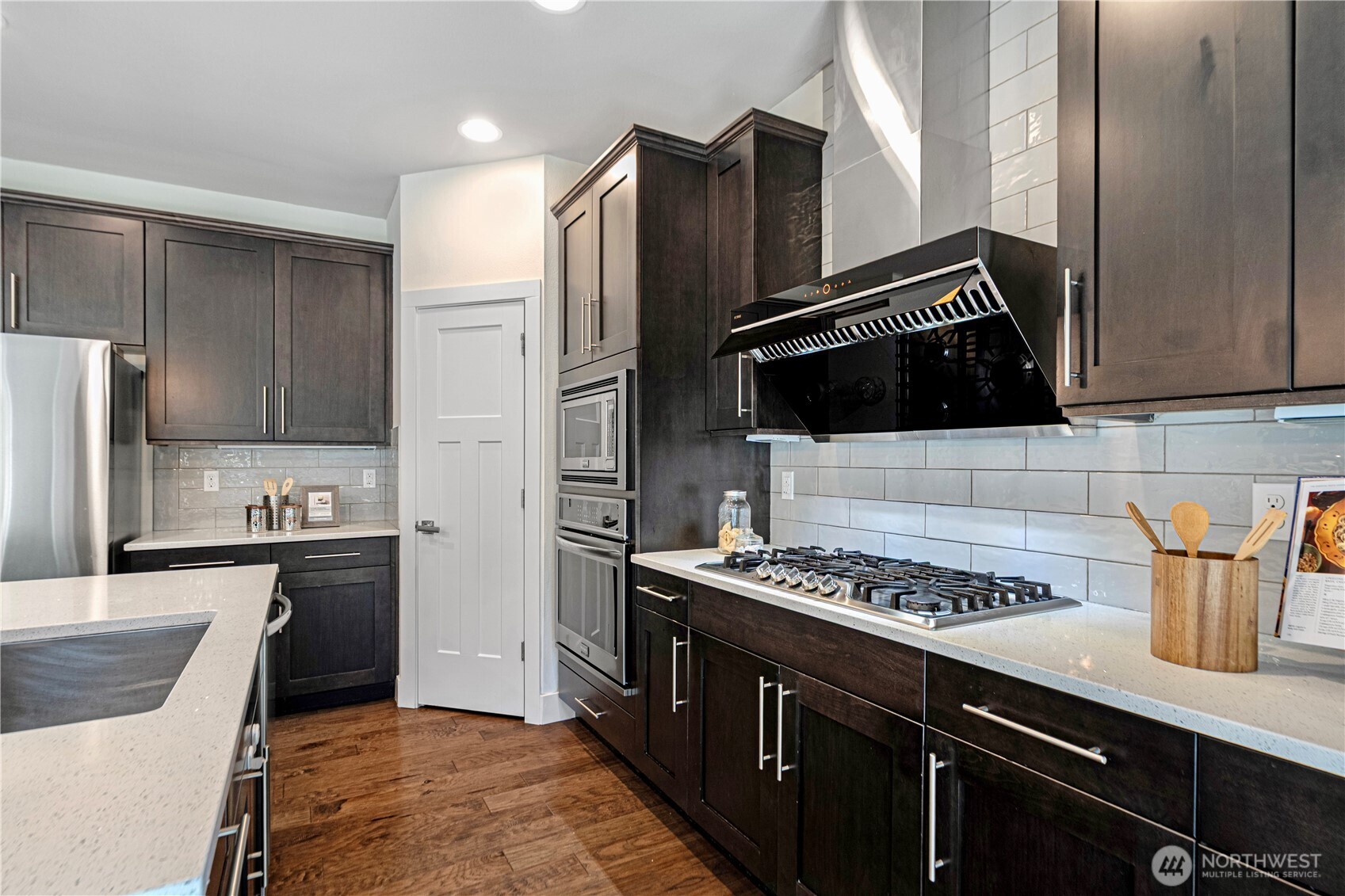 1130 199th Street Southeast Bothell, WA 98012 - Photo 10 of 33 a kitchen with stainless steel appliances granite countertop a stove refrigerator and sink