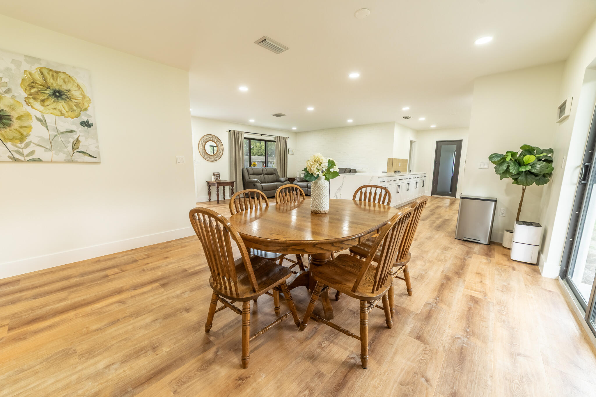 809 Southeast 12th Street Okeechobee, FL 34974 - Photo 13 of 62 a view of a dining room with furniture and wooden floor