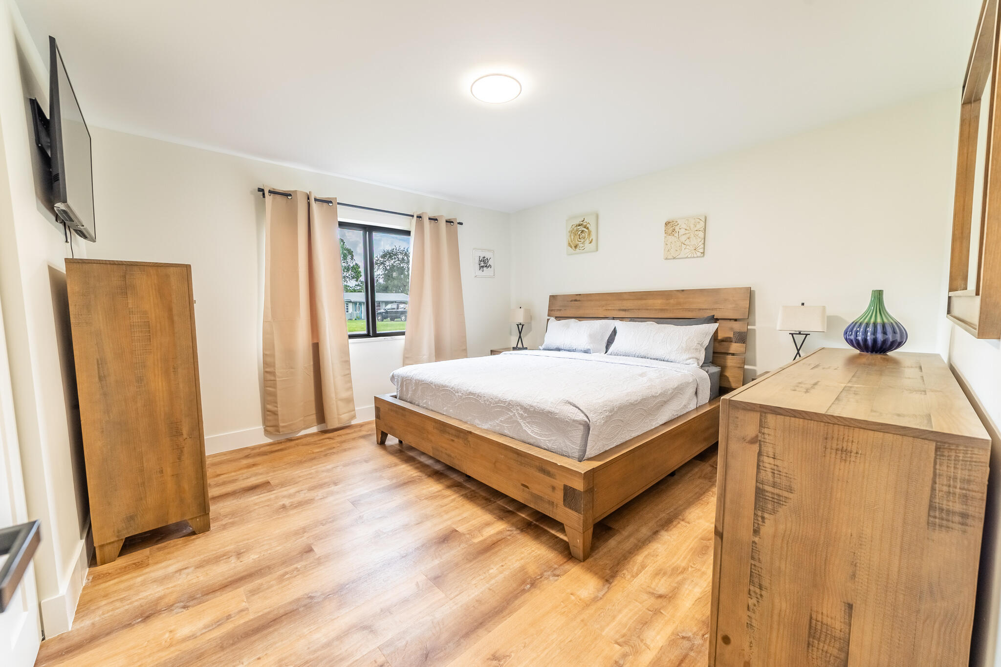 809 Southeast 12th Street Okeechobee, FL 34974 - Photo 15 of 62 a bedroom with a bed and wooden floor