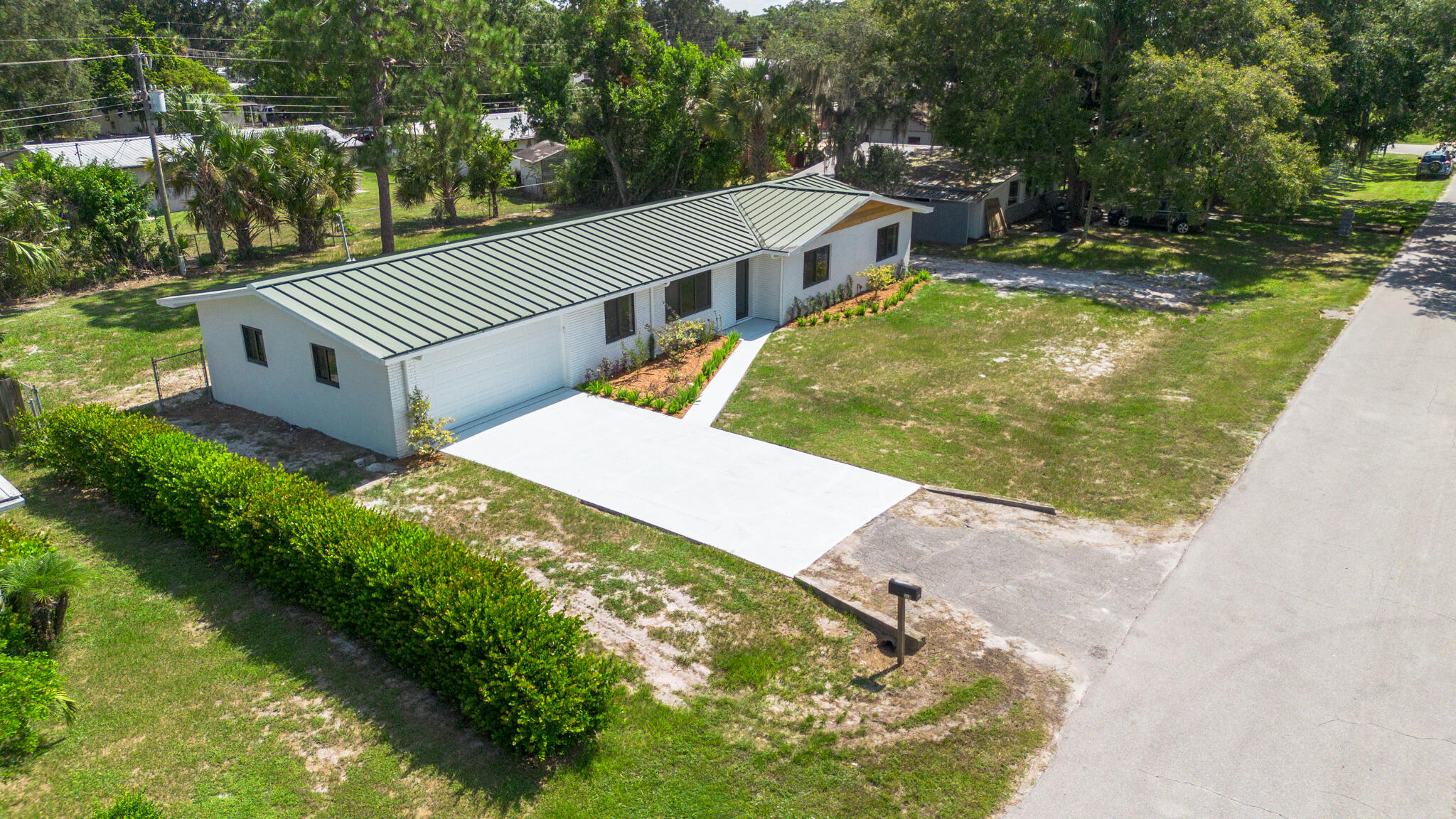 809 Southeast 12th Street Okeechobee, FL 34974 - Photo 57 of 62 a view of a swimming pool with a yard and large trees