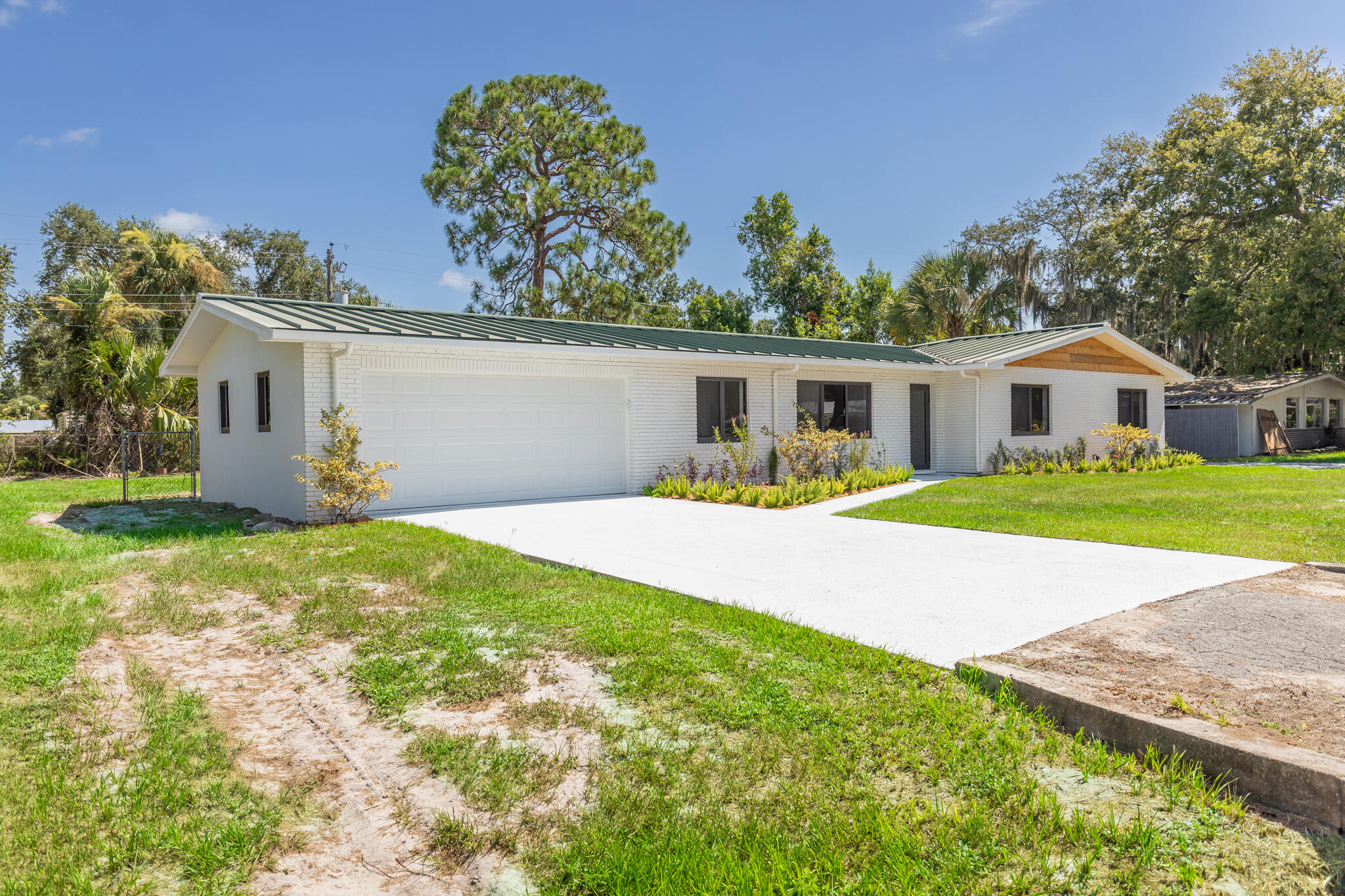 809 Southeast 12th Street Okeechobee, FL 34974 - Photo 61 of 62 a view of house with garden space and sitting area