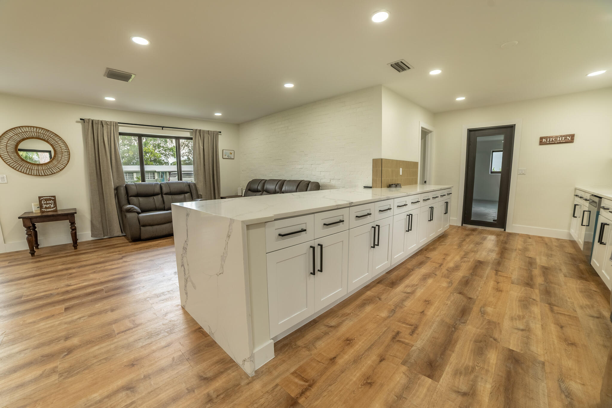 809 Southeast 12th Street Okeechobee, FL 34974 - Photo 8 of 62 a large kitchen with stainless steel appliances granite countertop a large stove a sink dishwasher and a refrigerator with wooden floor